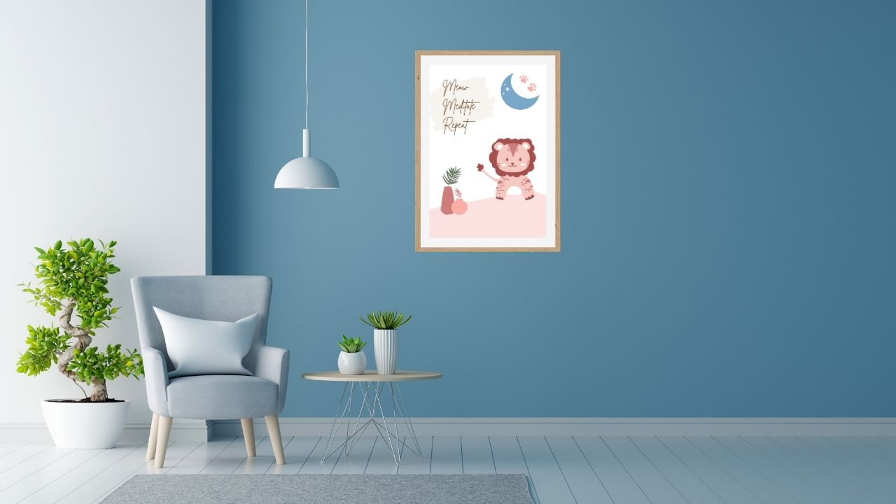 Modern living room with a blue wall, gray armchair, small table with plants, and framed artwork which has a Cute cat meditation wall art printable with quote “Meow. Meditate. Repeat.” – minimalist boho design featuring meditating cat, moon, and indoor plants – digital download for zen home decor